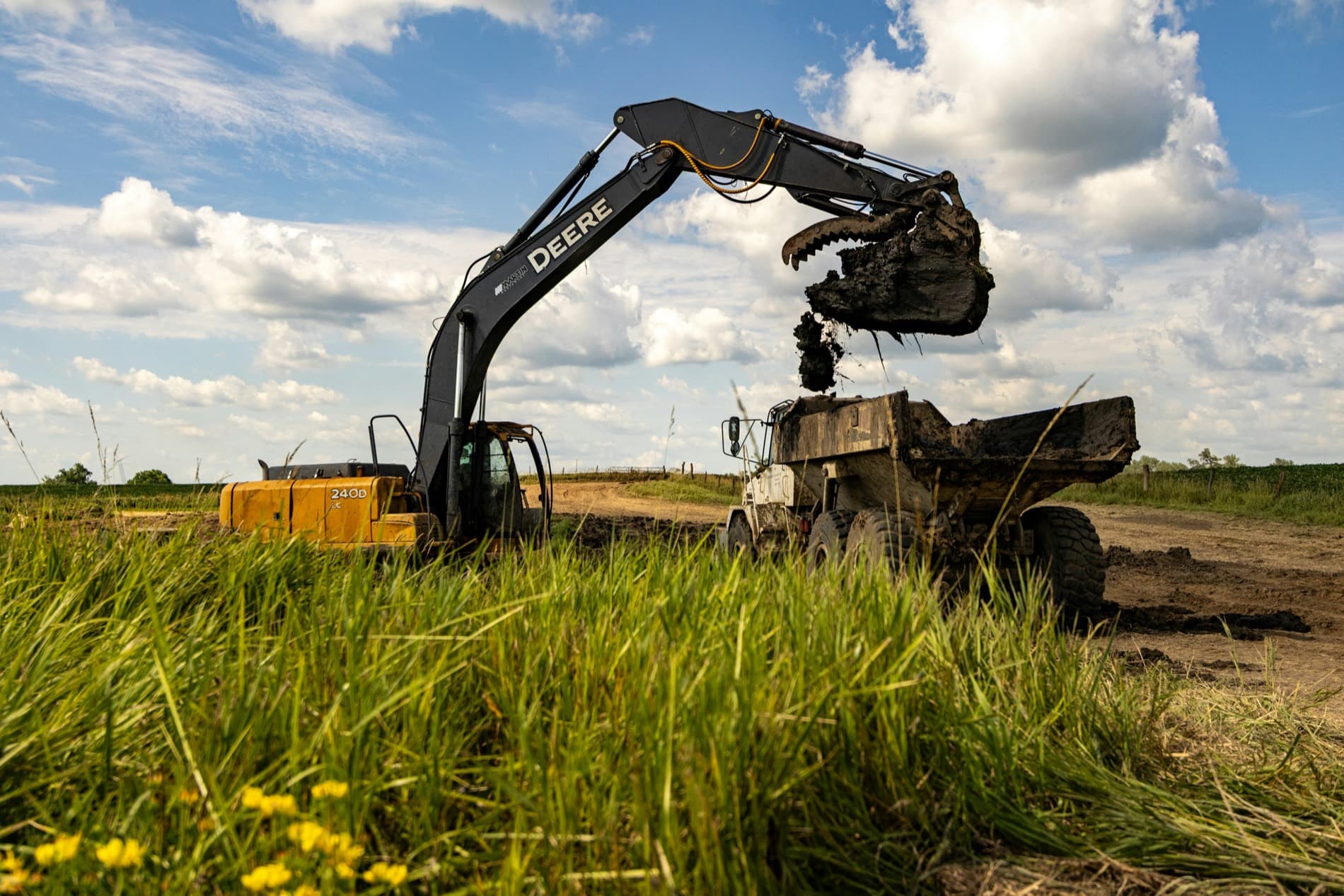 Excavator loading a dump truck at a construction site